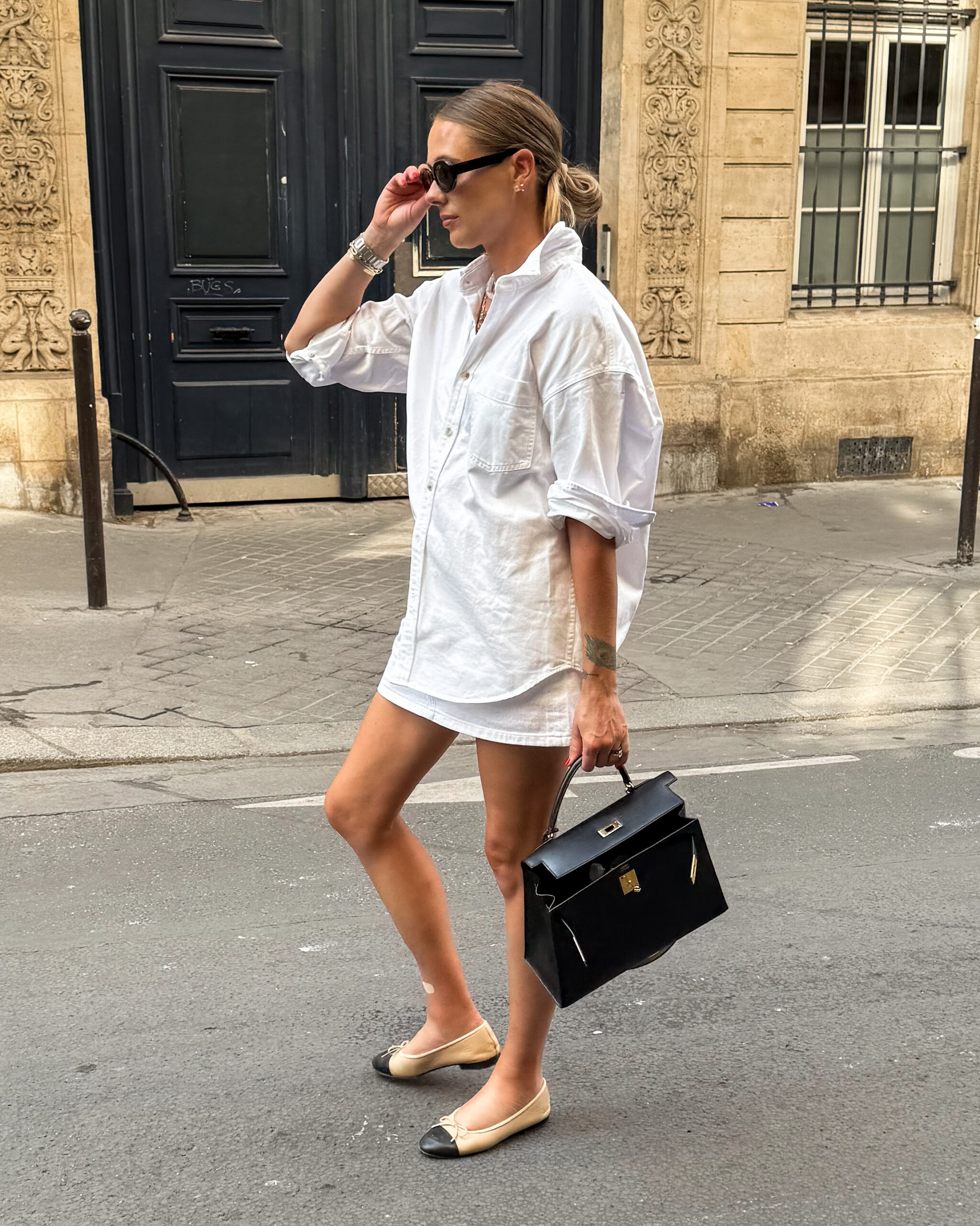 Fashion Jackson Wearing Aritzia White Button Down Denim Shirt Aritzia White Denim Mini Skirt Chanel Ballerinas Hermes Kelly Black Handbag Paris Summer Street Style