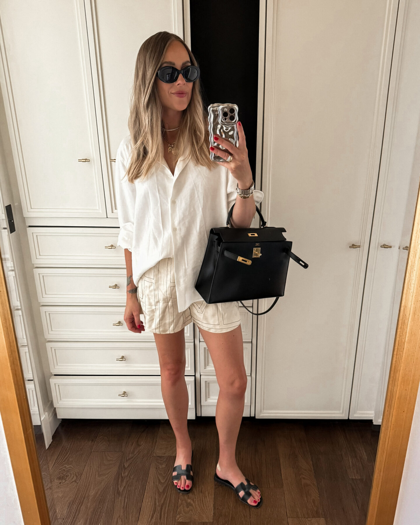 Fashion Jackson Wearing White Button Up Shirt Toteme Embroidered Logo Silk Shorts Hermes Oran Black Sandals Hermes Kelly 32 Black Box Sellier Leather Womens Paris Summer Outfit