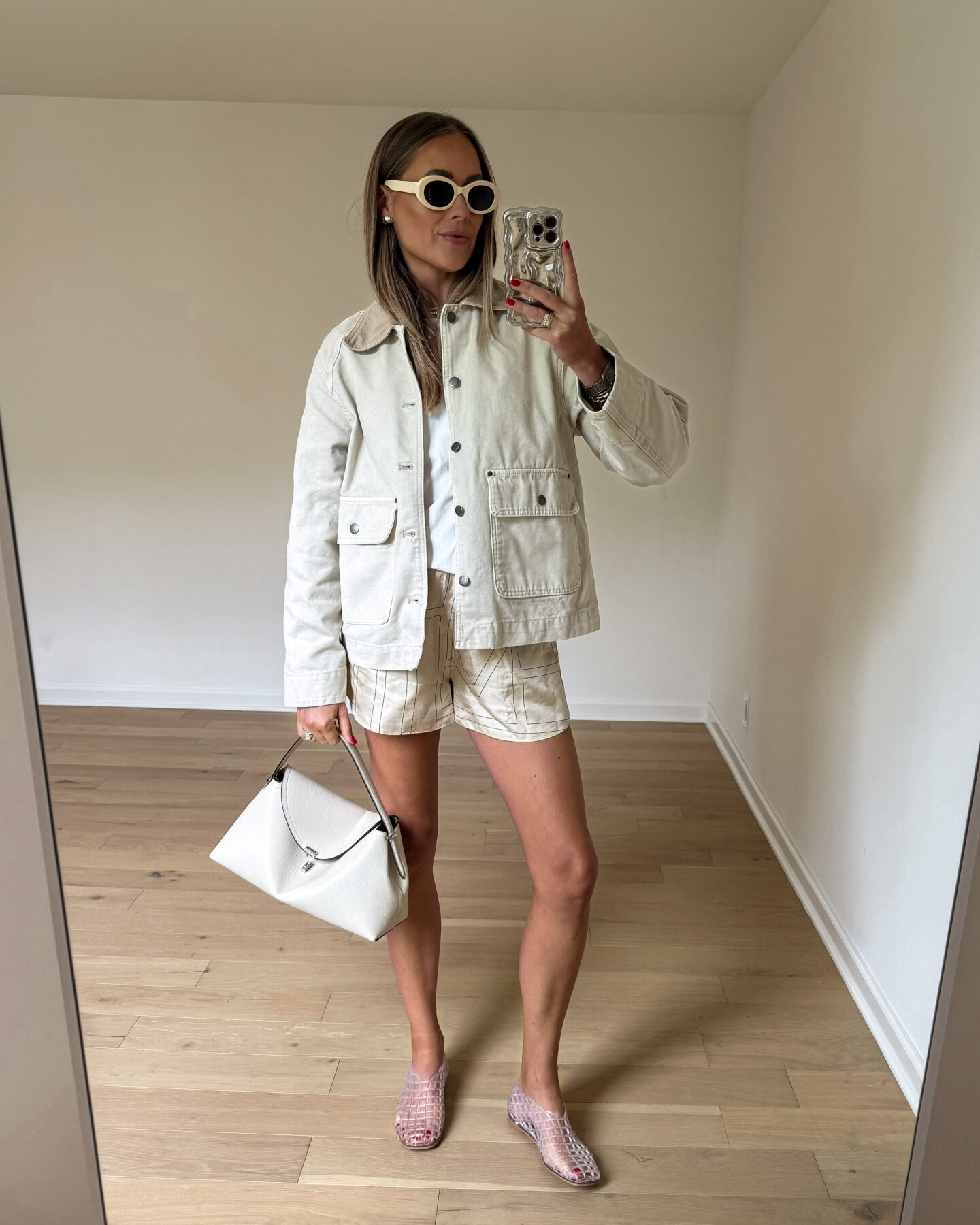 Fashion Jackson Wearing Beige Barn Jacket White Tshirt Toteme Embroidered Logo Silk Shorts Amazon Clear Jellies Toteme T-Lock Handbag Milk Womens Summer Outfit Idea Womens Fall Outfit Idea